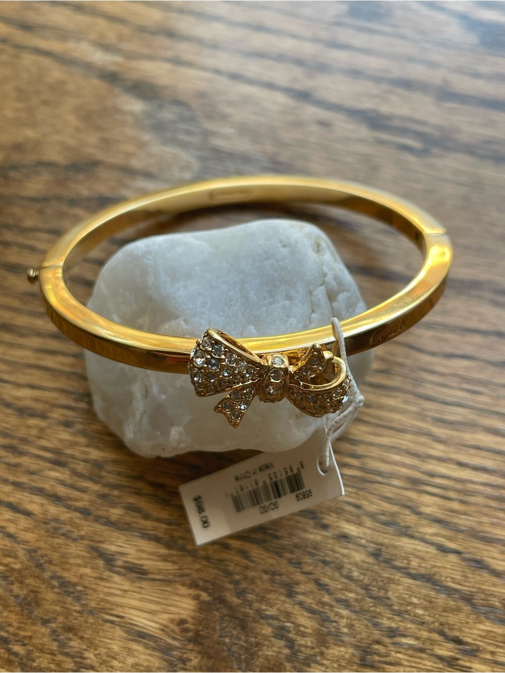 Coach Gold-Tone Crystal Bow Hinged Bangle Bracelet